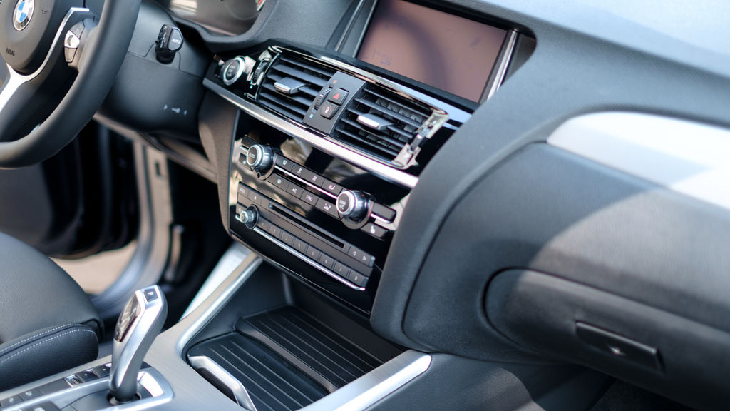 Vehicle interior with ceramic IR window tint and protected leather seats